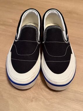 Vans Kid’s Black and White Slip-On with Blue Sole Stripe